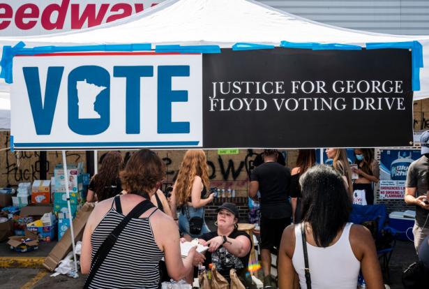 A voter registration booth at a memorial site for George Floyd.