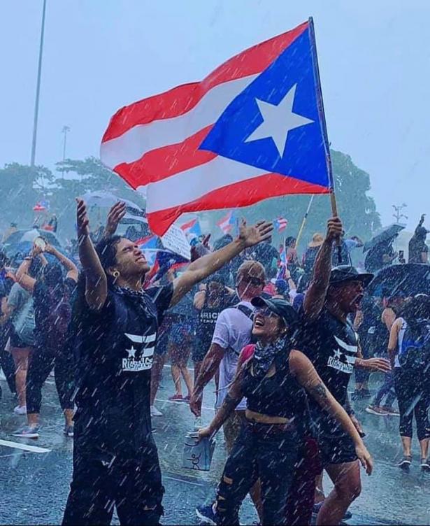 Protesters rejoicing in the rain in San Juan, Puerto Rico
