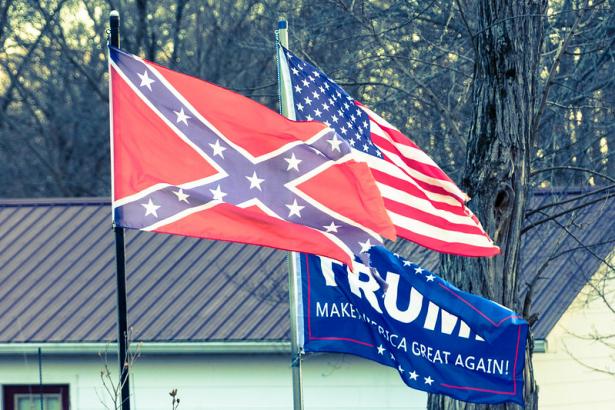 The Confederate Flag, the US Flag, and a Donald Trump flag. 