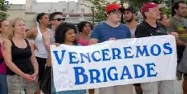 demonstrators holding Venceremos Brigade banner