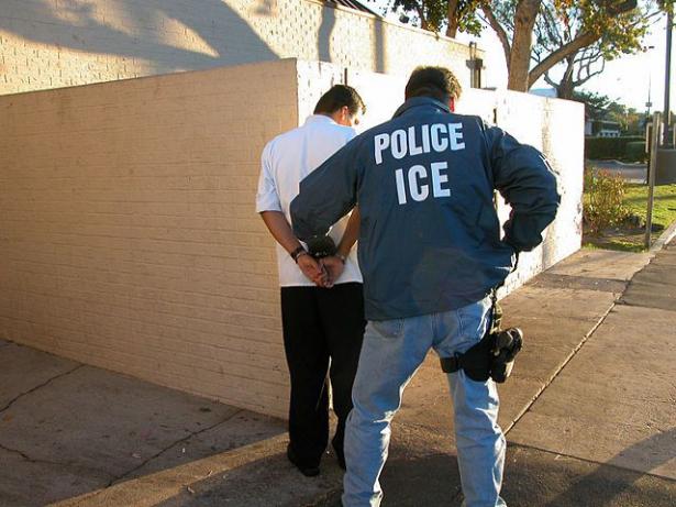 ICE agent handcuffing man