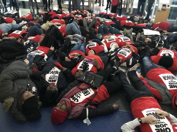 Hard-pressed workers stage “die-in” at JFK Airport.