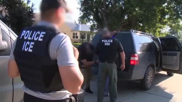 ICE agents arresting immigrant man