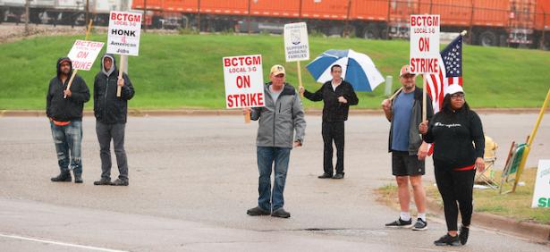 Workers holding signs that say:  BCTGM On Strike