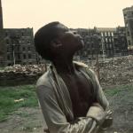 young Black man in vacant lot