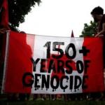 Banner "150 years+ Genocide"