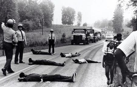 Black protestors lie on the road in 1982 to block dumping in a North Carolina landfill.