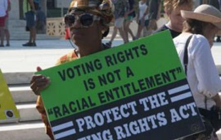 A protester decries the 2013 Supreme Court ruling on the Voting Rights Act.