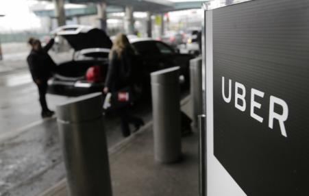 A sign marks a pick-up point for the Uber car service at LaGuardia Airport in New York. 