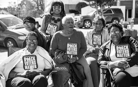 Black women with Black Voters Matter signs and fans