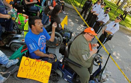 People in wheelchairs confronting police