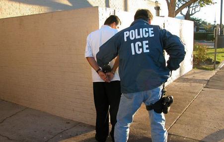 ICE agent handcuffing man