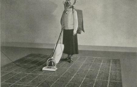 Woman vacuuming.