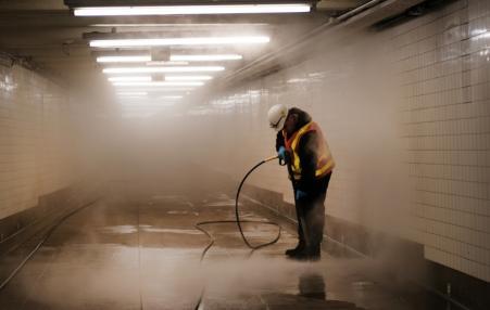 Worker seen cleaning a subway station